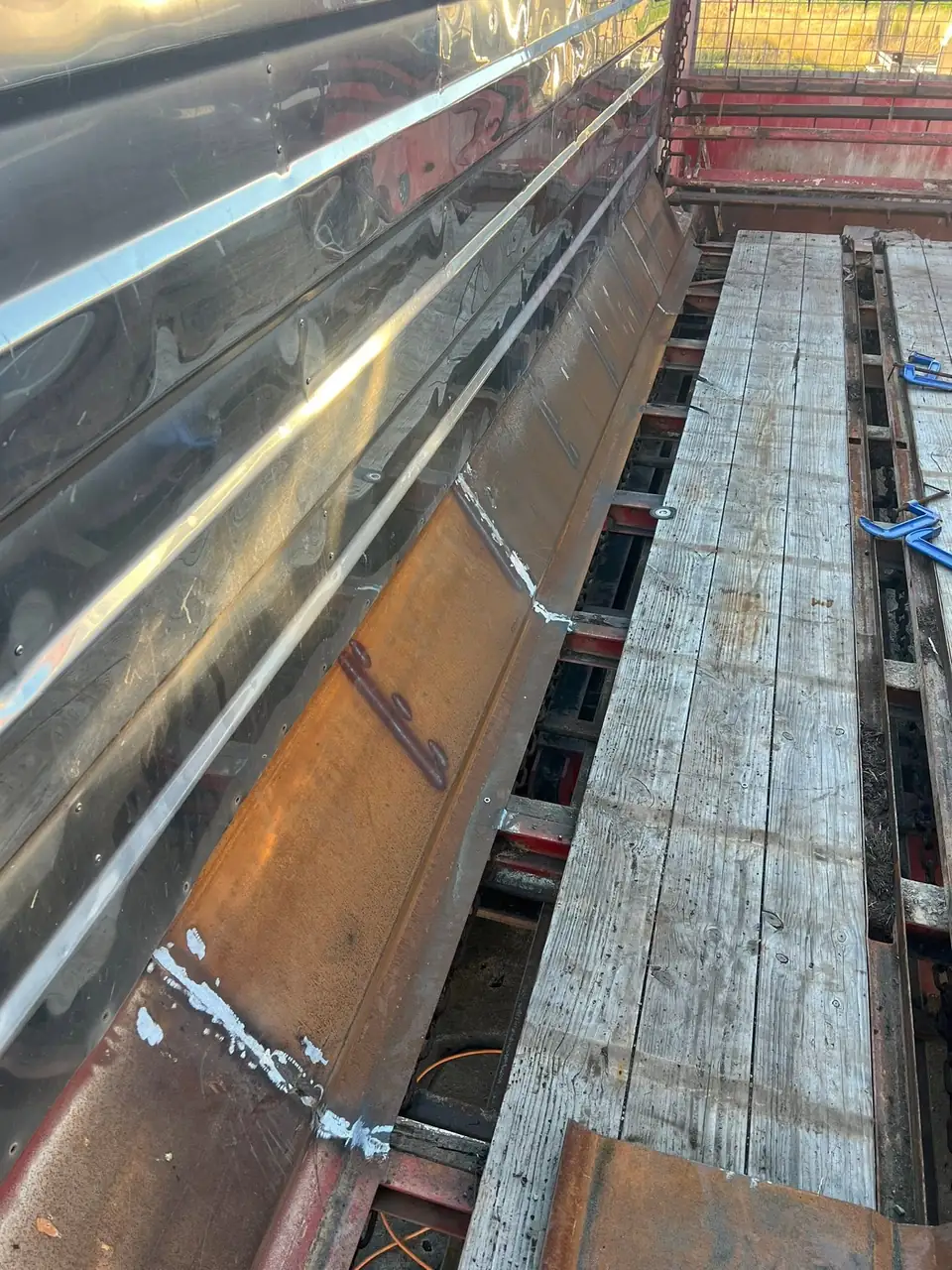 Replaced side panel and deck timbers along the length of the silage wagon